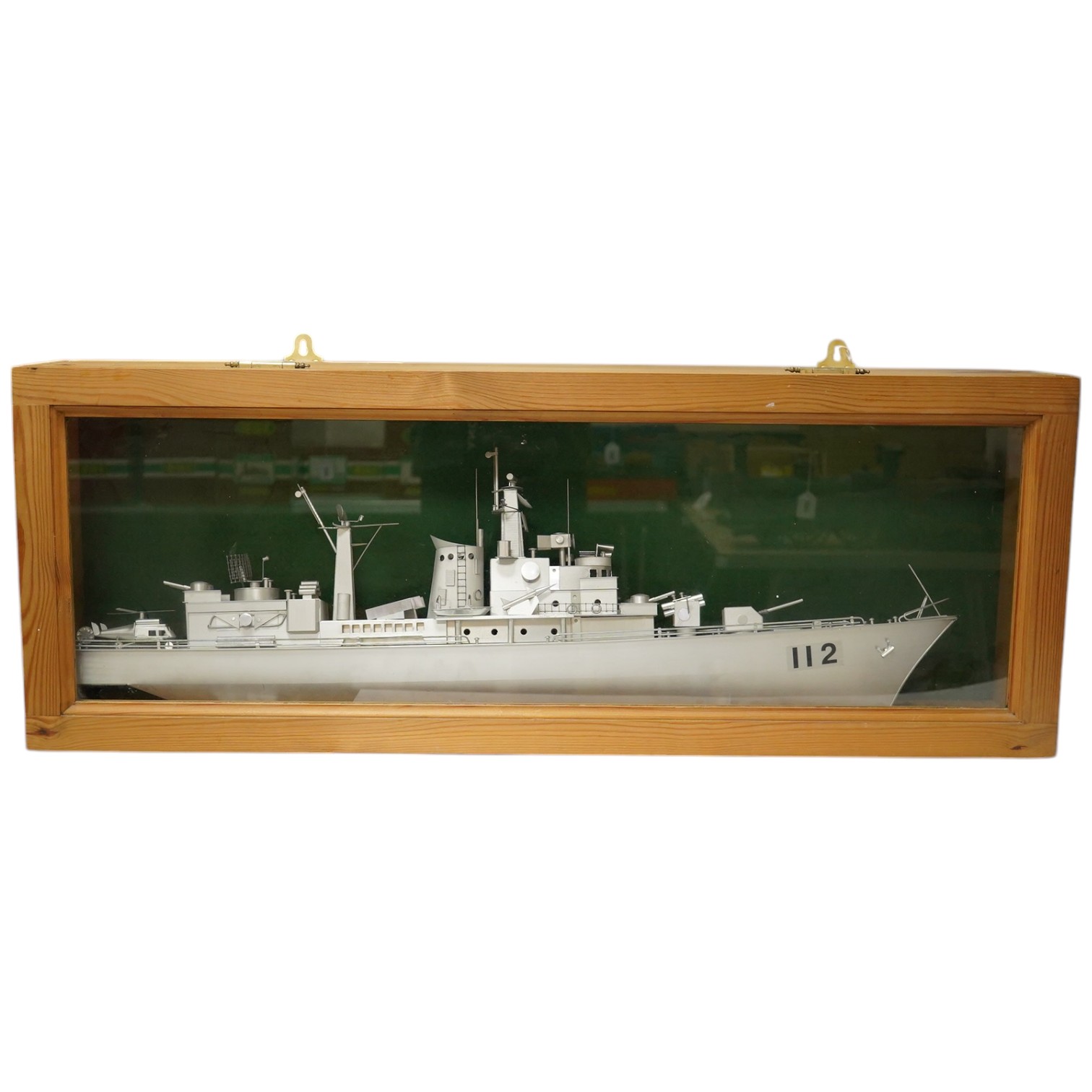 A pine cased aluminium model of a naval frigate, hull 86cm long, display case 96.5 x 18 x 36cm. Condition - good.